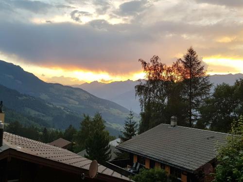 a view of a sunset from a house at Apartment Chalet Papillon by Interhome in Bürchen