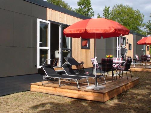 a group of chairs and an umbrella on a deck at Holiday Home Toni by Interhome in Wemding