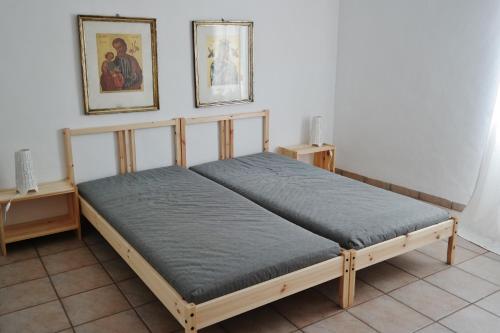 a bed sitting in a room with two tables at Chalet Paraiso in Sella