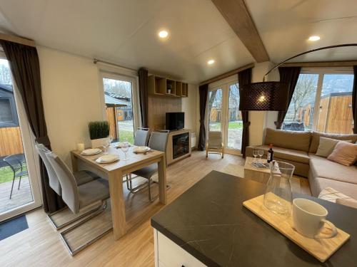 a kitchen and living room with a table and a couch at Holiday Home Tiny Haus Tania by Interhome in Riedenburg