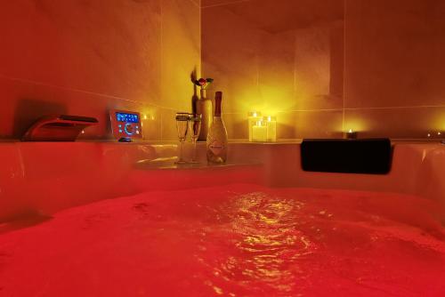a room with a red bed with lights on it at Appartement Bulle d'antan en cœur de ville - Monument classé historique - Grand Jaccuzi in Castres