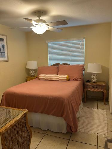 a bedroom with a bed with a ceiling fan at A Beach Retreat on Casey Key in Venice