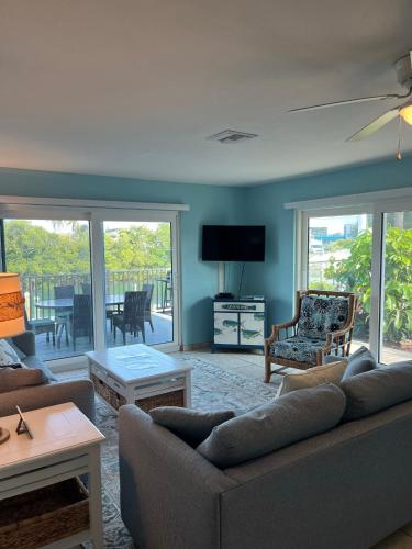 a living room with a couch and a tv at A Beach Retreat on Casey Key in Venice