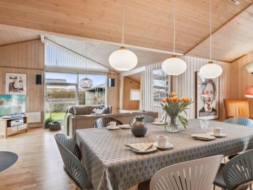 uma sala de jantar e sala de estar com mesa e cadeiras em Holiday Home Aron - 225m from the sea in SE Jutland by Interhome em Børkop