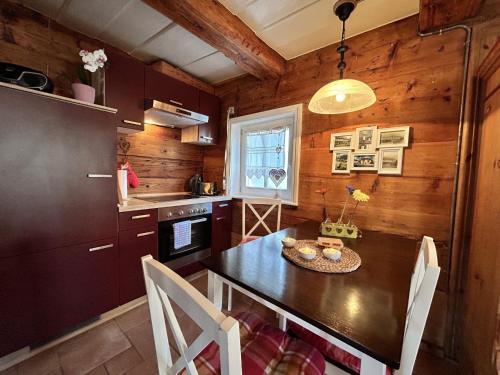 a kitchen with a table and chairs in a room at Holiday Home Selma by Interhome in Großschönau