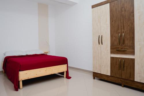 Schlafzimmer mit einem Bett und einem Holzschrank in der Unterkunft Apartamento Santo Antonio I - T3 in Praia