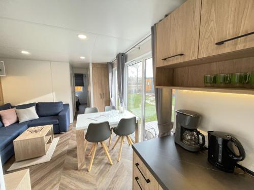 a kitchen and living room with a couch and a table at Holiday Home Tiny Haus Xandra by Interhome in Riedenburg