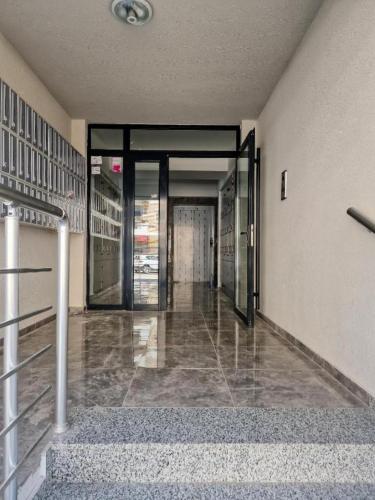 an empty hallway with glass doors in a building at Tuse Lux apartments in Skopje