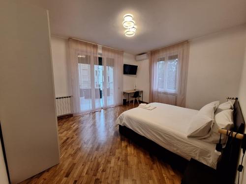 een slaapkamer met een bed en een houten vloer bij Casa Vanessa in Arezzo