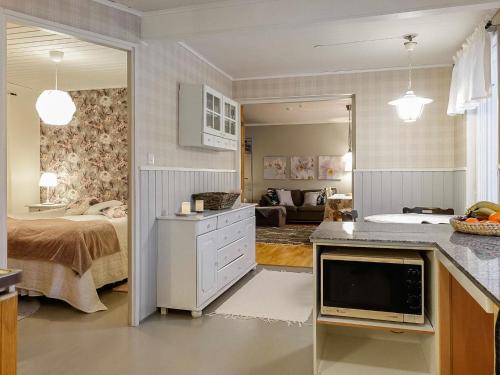 a bedroom with a bed and a living room at Holiday Home Saajola by Interhome in Leppäjärvi
