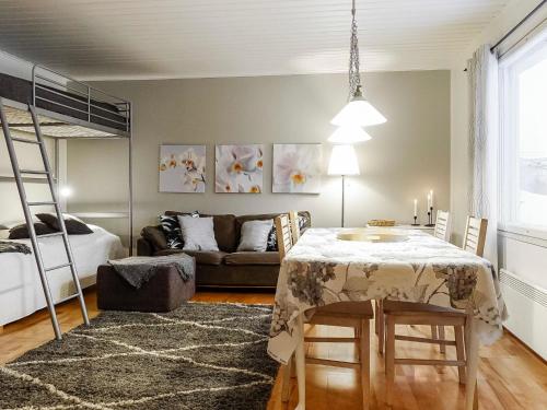 a living room with a table and a couch at Holiday Home Saajola by Interhome in Leppäjärvi