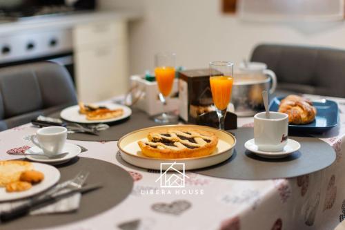 a table topped with plates of food and orange juice at LIBERA HOUSE - Sweet Apartments in San Salvo