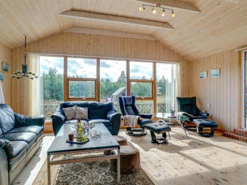 a living room with a couch and a table at Holiday Home Svenger - 800m from the sea in NW Jutland by Interhome in Fjerritslev