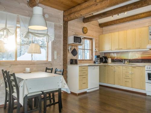 a kitchen and dining room with a table and chairs at Holiday Home Puljunharju by Interhome in Sattanen