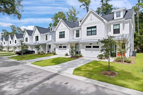 a large white house with a driveway at Luxury Getaway! Brand New 4BD! Near Coligny Beach in Hilton Head Island
