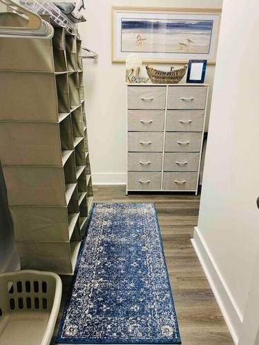 a room with a closet with a dresser and a rug at Luxury Getaway! Brand New 4BD! Near Coligny Beach in Hilton Head Island