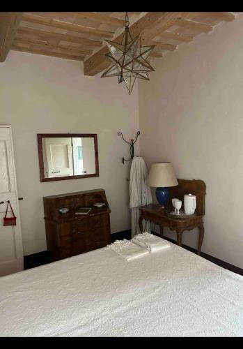a bedroom with a bed and a table with a lamp at Agriturismo Bibiano38 in Treia