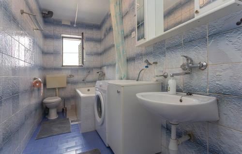 a small bathroom with a sink and a toilet at House Soul in Oklaj