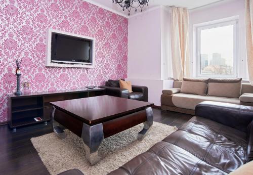 a living room with a couch and a coffee table at River view Cathedral Apartment in Vilnius