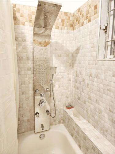 a bathroom with a bath tub with a shower at Cozy Chateau in Heart Ease