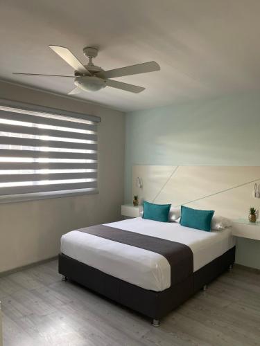 a bedroom with a large bed with a ceiling fan at Constanza Lofts Executives en Zapopan Jalisco in Guadalajara