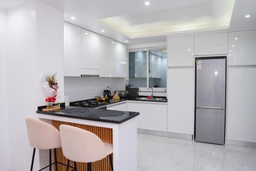 a white kitchen with white appliances and white cabinets at Saw Paradise in Praia T2 in Praia