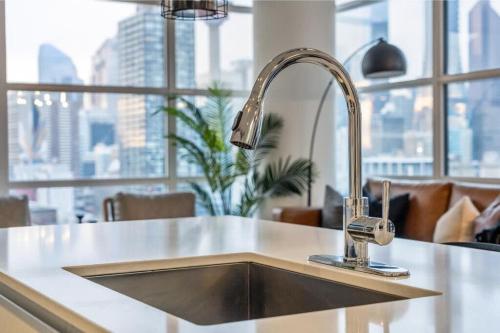 a kitchen sink in a kitchen with a large window at Manhattan in Calgary