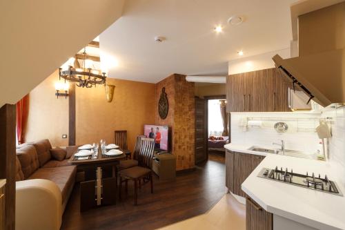 a kitchen and living room with a couch and a table at StoneBridgeLuxApart Free Parking in Rīga