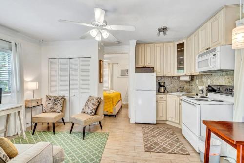 a kitchen with white appliances and a living room at Charming Cottage 1BR, Pool, Victoria Park in Fort Lauderdale
