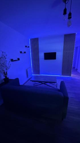 niebieski pokój z łóżkiem i kanapą w obiekcie Le Nouveau des Ponts w mieście Vierzon