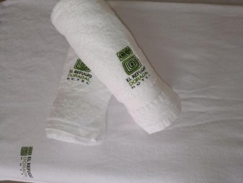 a roll of toilet paper sitting on top of a towel at Hotel El refugio Doradal in Puerto Triunfo