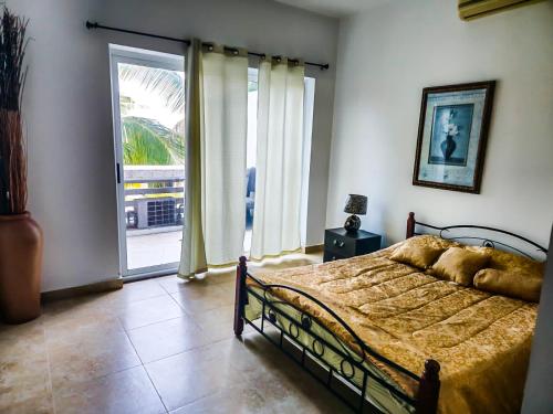 a bedroom with a bed and a large window at Rooming House in Playa Blanca