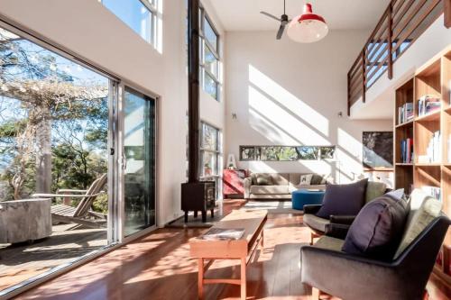 a living room with a large window and a couch at Mr Wooden Box Bush Retreat 5 minutes from the CBD in Inveresk