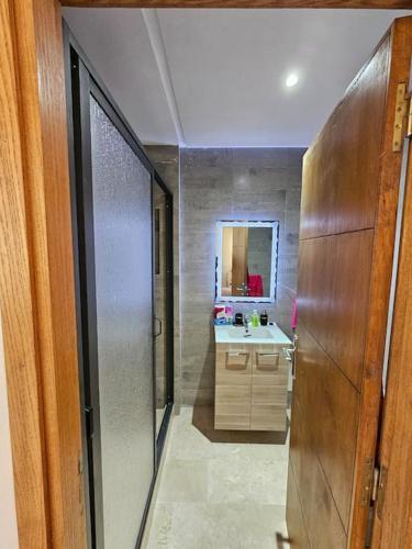 a bathroom with a sink and a mirror at Beachfront Gorgeous Flat in Tangier in Tangier