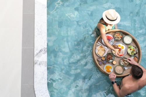 a man and woman in a boat in the water at Seamira House Huahin in Hua Hin