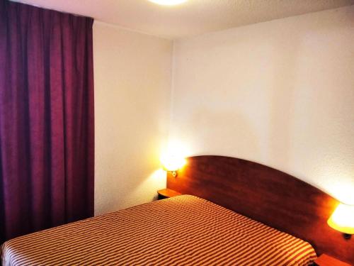 - une chambre avec un lit et deux lumières allumées dans l'établissement Résidence Pic Du Midi - 2 Pièces pour 4 Personnes 664, à La Mongie