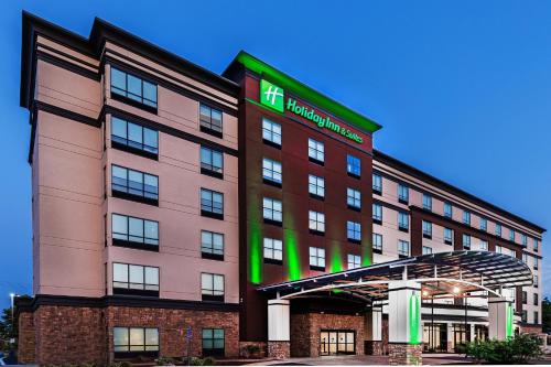 an image of a hotel with a sign on it at Holiday Inn Hotel & Suites Tulsa South by IHG in Tulsa