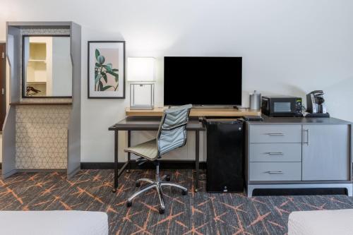 an office with a desk with a computer and a chair at Holiday Inn Hotel & Suites Tulsa South by IHG in Tulsa