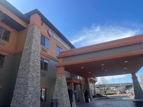 a building with a clock on top of it at Best Western Plus KC Speedway Inn & Suites in Kansas City