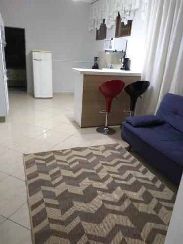 a living room with a couch and a red stool at Wana casa 2 Requinte e conforto in Sao Jose do Rio Preto