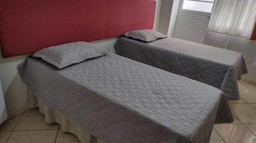 two beds sitting next to each other in a room at Wana casa 2 Requinte e conforto in Sao Jose do Rio Preto