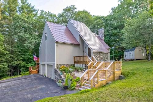 a large white barn with a porch and a driveway at Gilford Family Retreat in Gilford