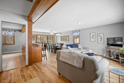 a living room with a couch and a table at Gilford Family Retreat in Gilford