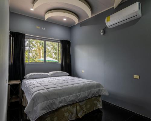 um quarto com uma cama grande e uma janela em Villa el Descanso em San Pedro