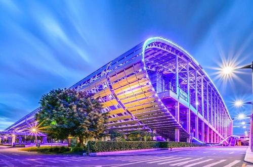 a large building is lit up at night at Guangzhou Yashay International Apartment - Pazhou Convention and Exhibition Centre in Guangzhou