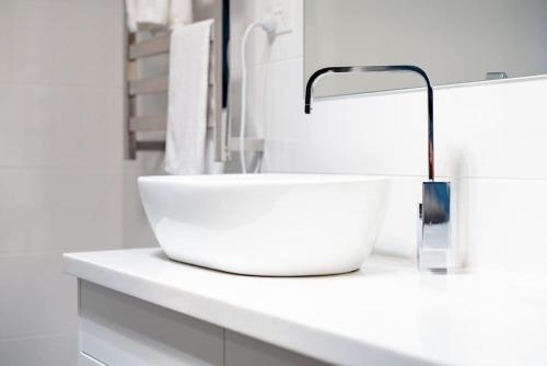 a bathroom with a white sink on a counter at Modern Home for Large Groups or Families in Newstead