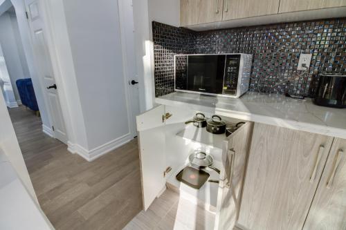 uma cozinha com um balcão e um micro-ondas em Beautiful 3 bedroom house, 20 minutes to Toronto downtown, free parking and Wifi em Toronto