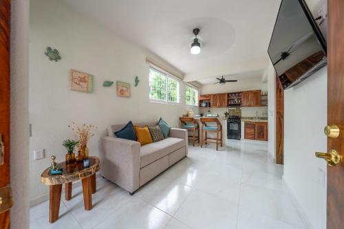 a living room with a couch and a table at Villas EVA - Zihuatanejo in Zihuatanejo