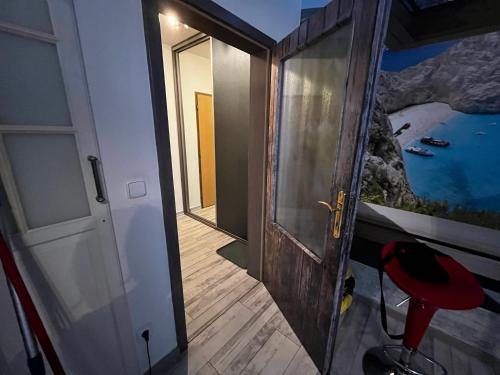 a door to a room with a view of the ocean at MONFas APARTMENT PROVENCE IN PRAGUE in Prague
