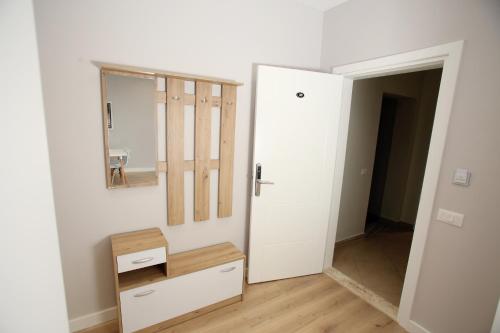 a room with a mirror and a drawer and a door at The Met Apartments in Durrës